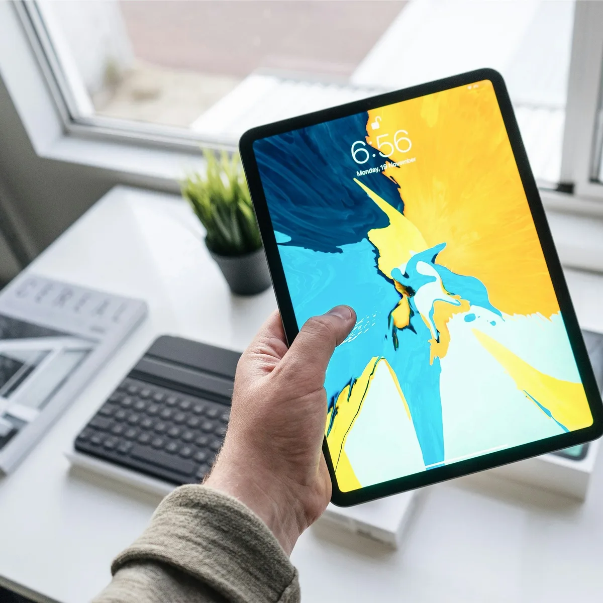 person holding turned-on black iPad