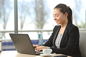 Remote employee working on a laptop in a café